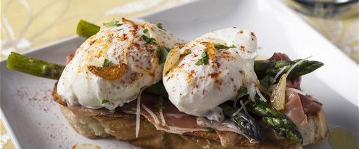 Poached Eggs with Serrano Ham and Garlic Asparagus on a square plate