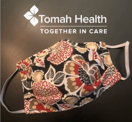 A homemade face mask with the Tomah Health logo