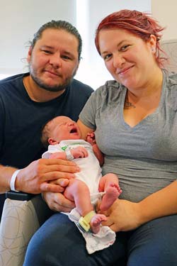 Mom and Dad pose with the first baby born at the new Tomah Health facility