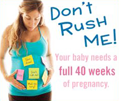 A pregnant woman looking at and cradling her stomach, which has sticky notes stuck to it