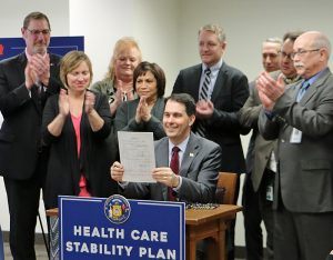 Wisconsin Governor Scott Walker signs the Health Care Stability Plan