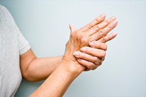 A person grabbing their hand in pain
