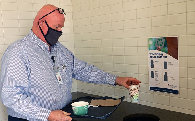 Steve Loging sorts recyclable items in the Tomah Health cafe.