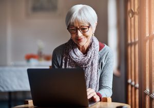 Shot of a senior woman using a laptop in a retirement home