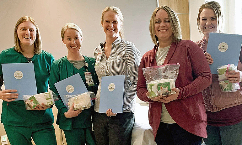 Nurses with Tomah Health's Women's Health Services pose with new mom bags