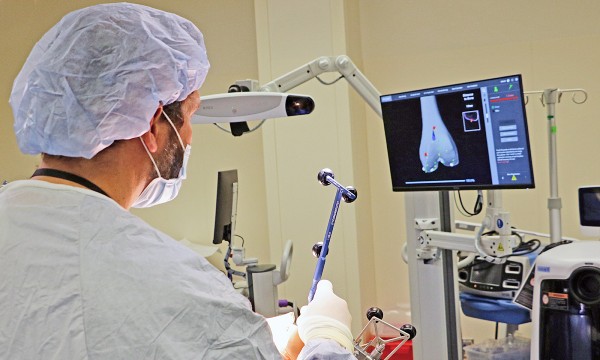 Dr. Aaron Butler performs a knee replacement procedure using robotic-assisted technology