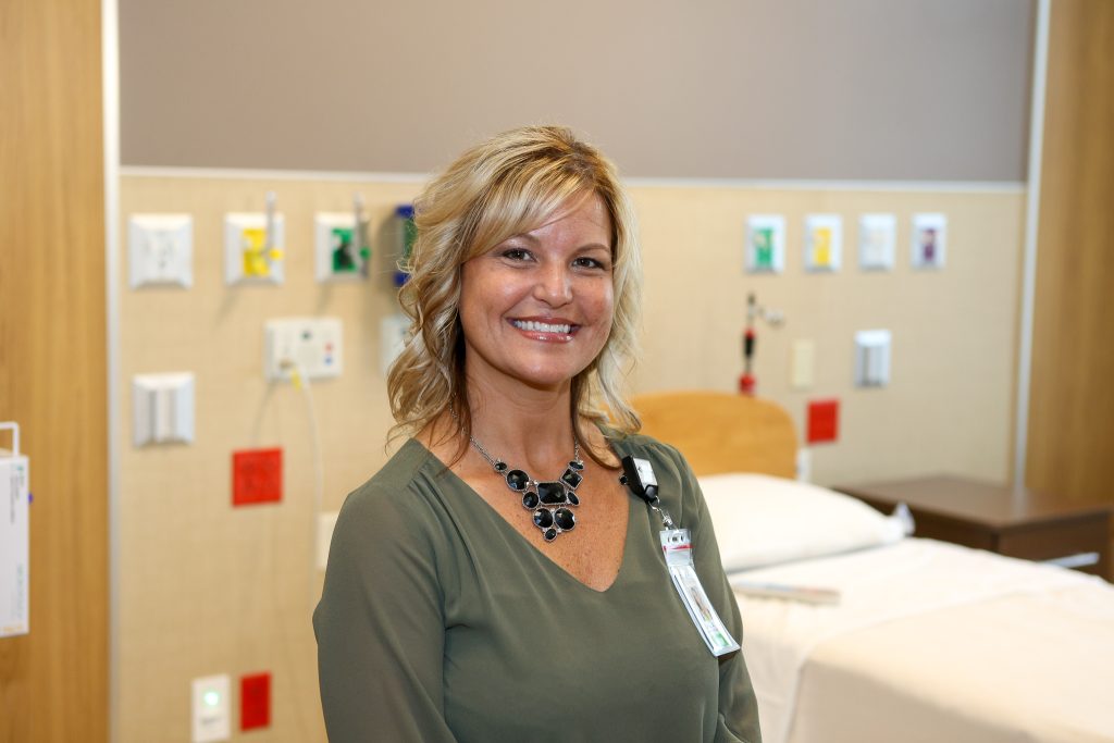 Linsey Rezin standing next to a hospital bed