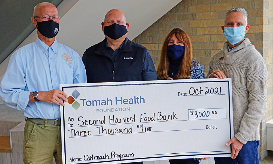 Second Harvest Foodbank of Southern Wisconsin accepts a ceremonial check from the Tomah Health Community Foundation