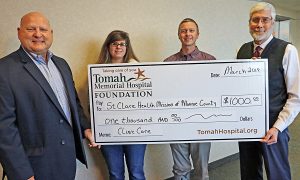 Tomah Health Foundation officials present a ceremonial check to officials from St. Clare Health Mission