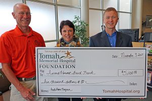 Second Harvest FoodShare accepts a ceremonial check from the Tomah Health Foundation