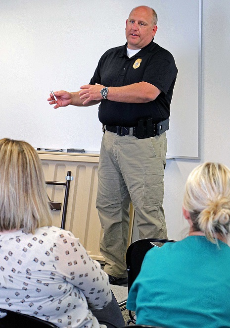 Tomah Police Sergeant Chris Weaver highlights a number of points during a presentation to Tomah Health staff.