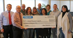 TRICOR officials present a ceremonial check to Tomah Health officials