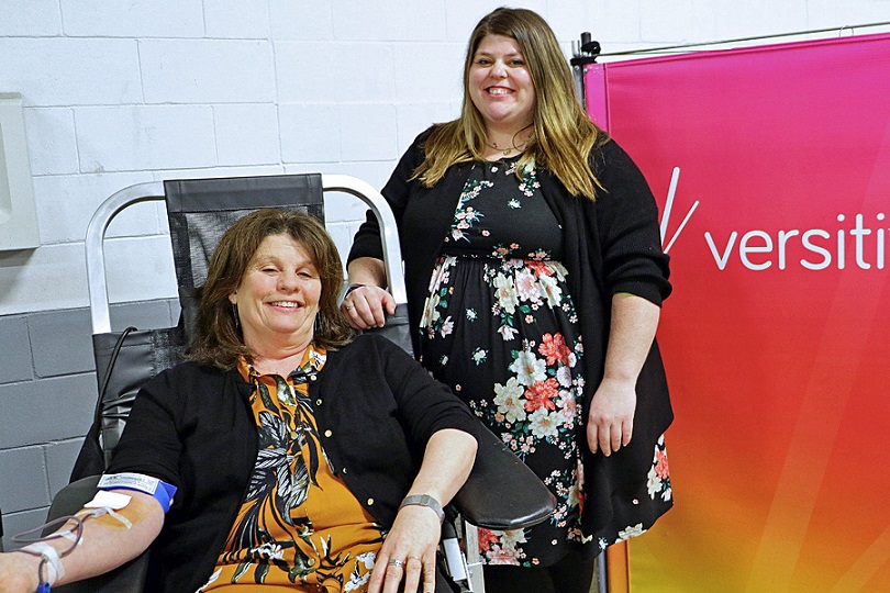 Theresa Pierce, left, and Katie Pierce pose for the camera as Teresa donates blood.