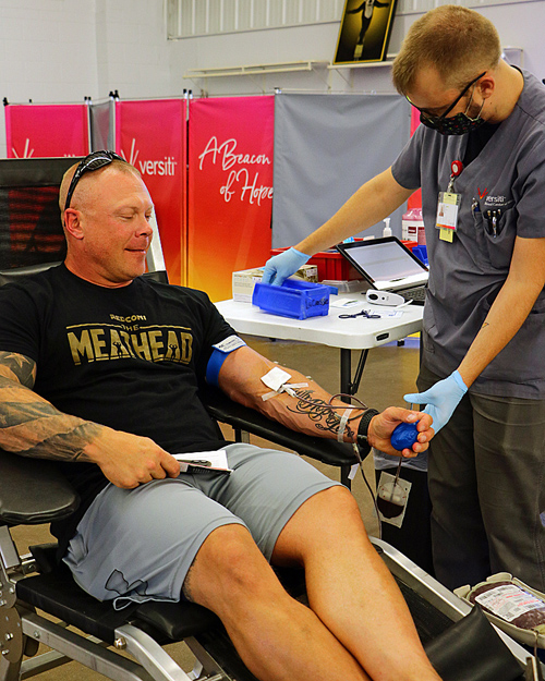 Tomah Health resident listens to instructions from a donor specialist during a blood drive.