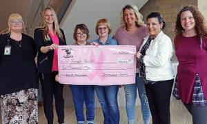 Treasured Chests presents a ceremonial check to Tomah Health providers in nursing and women's health