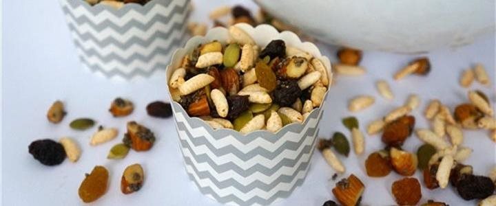 Small cups on a tabletop filled with trailmix
