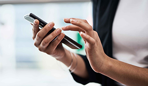 A woman tapping on a cellphone