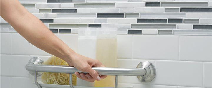 A person holding onto a bar in the tub