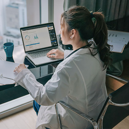 doctor working in office looking out window