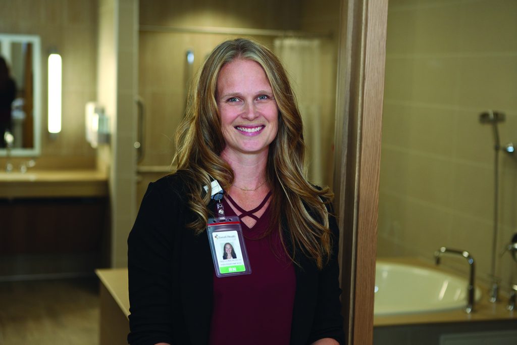 Carrie Lord standing in the water birthing suite at Tomah Health