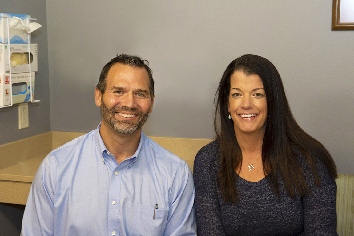 Dr. Aaron Butler sitting next to patient Maryah in a hospital room