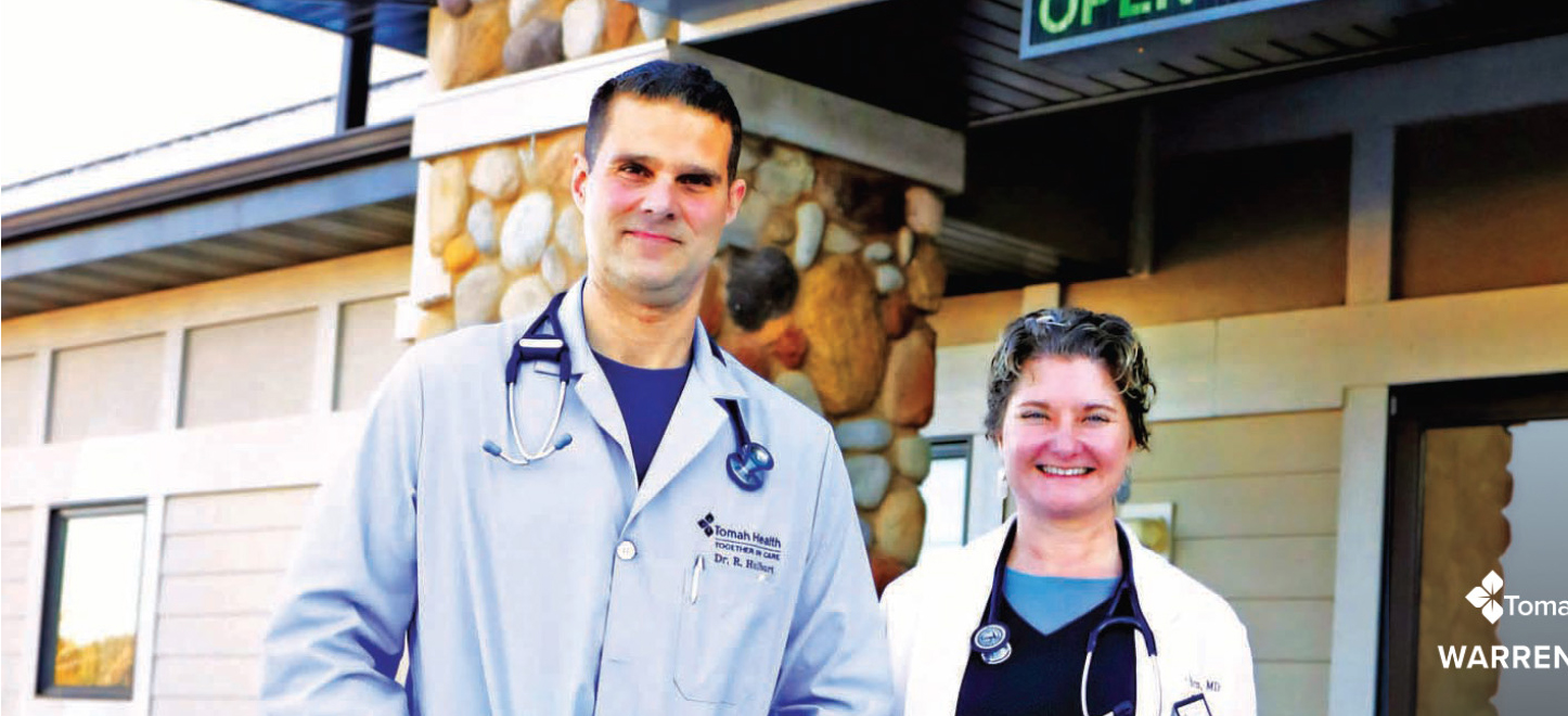 Drs. Hulburt and Boulden in front of the Warrens Clinic front door in Warrens, Wisconsin